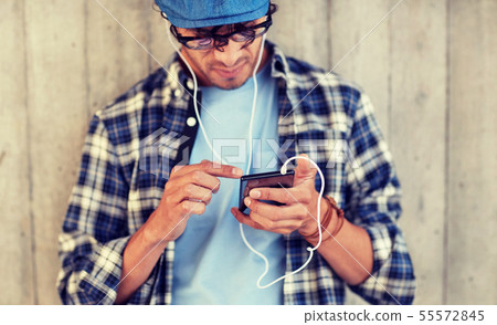 man with earphones and smartphone listening music 55572845
