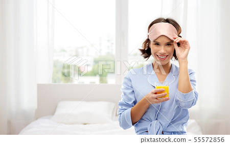 woman in pajama and sleeping mask with juice woman in pajama and sleeping mask with juice 55572856