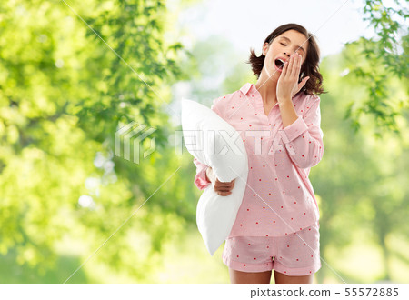 sleepy yawning young woman in pajama with pillow sleepy yawning young woman in pajama with pillow 55572885