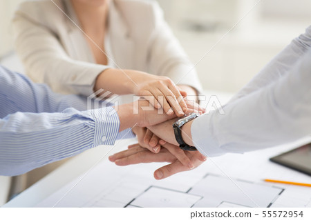 close up of business team stacking hands 55572954