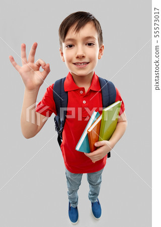 student boy with books and school bag showing ok 55573017