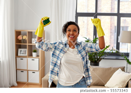 happy african woman with sponge cleaning at home 55573343
