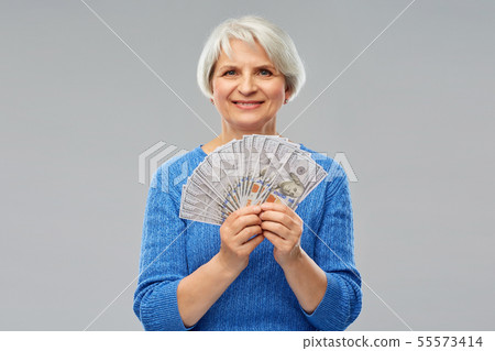 senior woman with hundred dollar money banknotes senior woman with hundred dollar money banknotes 55573414