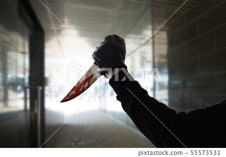 hand in glove with blood on knife over dark tunnel hand in glove with blood on knife over dark tunnel 55573531