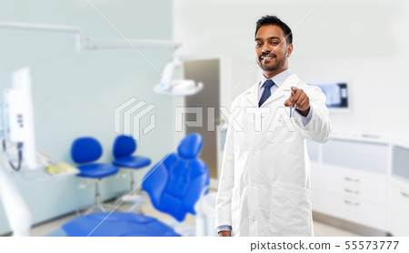 indian dentist pointing to you at dental clinic indian dentist pointing to you at dental clinic 55573777