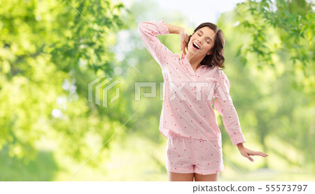 happy young woman in pajama stretching happy young woman in pajama stretching 55573797