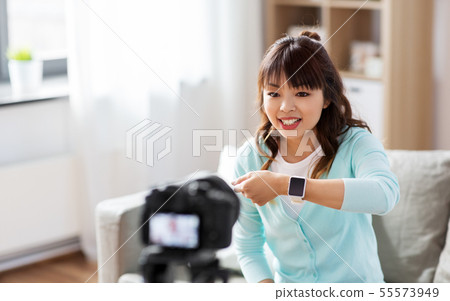 asian blogger makes video blog of smart watch 55573949