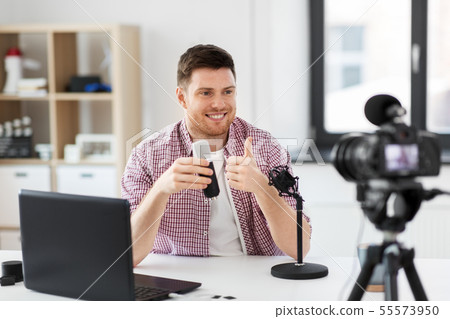 male blogger with microphone videoblogging 55573950