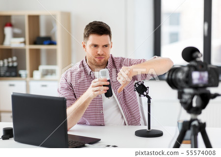 male blogger with microphone videoblogging 55574008
