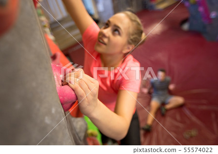 young woman exercising at indoor climbing gym 55574022