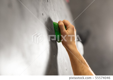male hand holding to indoor climbing wall 55574046