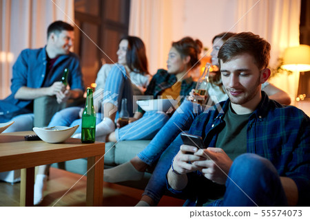 man with smartphone at home party man with smartphone at home party 55574073