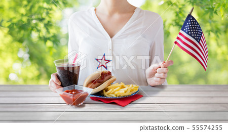 woman celebrating american independence day woman celebrating american independence day 55574255