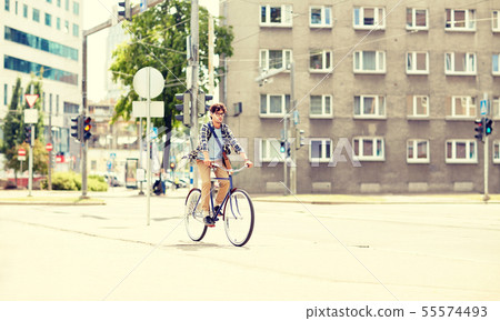 young hipster man with bag riding fixed gear bike 55574493