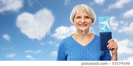 senior woman with passport and airplane ticket senior woman with passport and airplane ticket 55574599