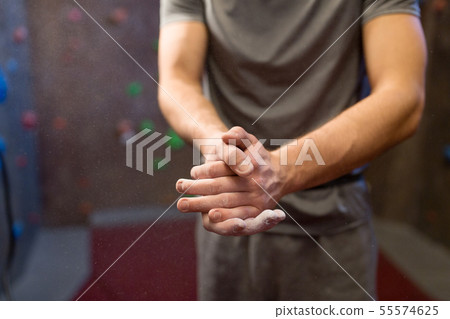male climber drying hands at indoor climbing gym male climber drying hands at indoor climbing gym 55574625
