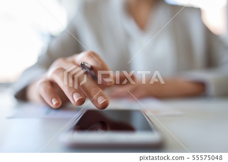 hand of businesswoman using smartphone at office hand of businesswoman using smartphone at office 55575048