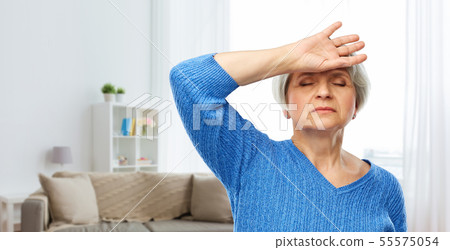 tired senior woman suffering from headache 55575054