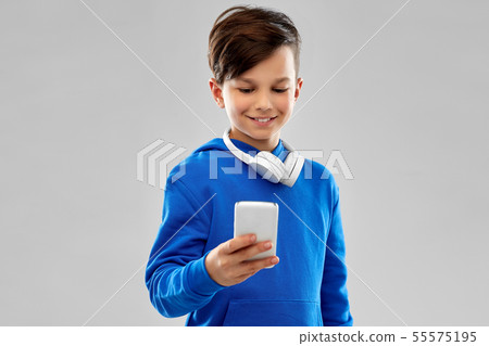smiling boy in blue hoodie using smartphone 55575195
