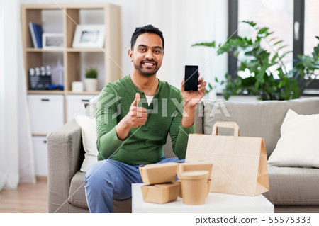 indian man using smartphone for food delivery indian man using smartphone for food delivery 55575333