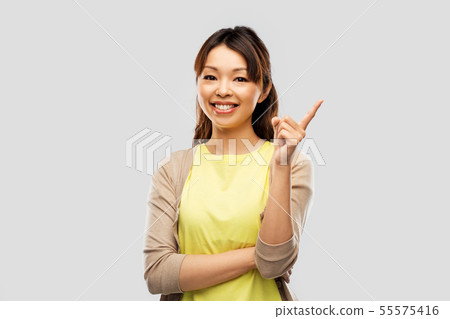 happy asian woman pointing finger up 55575416