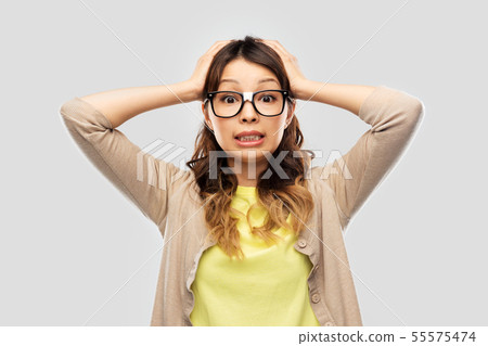 asian female student in glasses holding to head asian female student in glasses holding to head 55575474