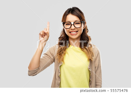 asian woman in glasses or student with finger up asian woman in glasses or student with finger up 55575476
