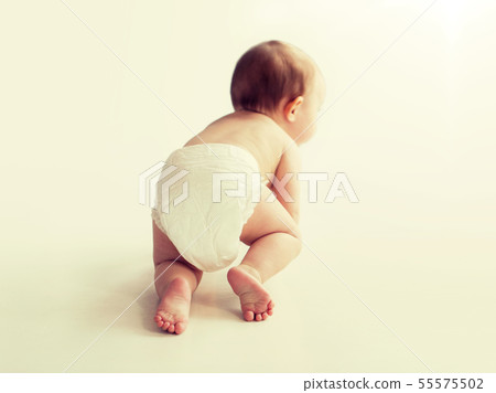 little baby in diaper crawling on white floor 55575502