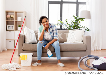 african woman or housewife after cleaning at home african woman or housewife after cleaning at home 55575652