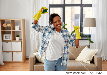 happy african woman with sponge cleaning at home happy african woman with sponge cleaning at home 55575653