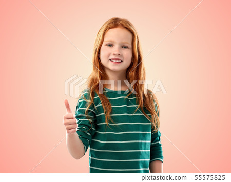 smiling red haired girl showing thumbs up 55575825