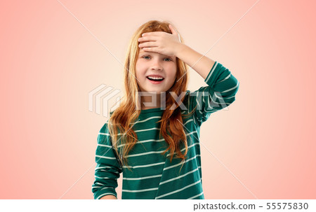 smiling red haired girl holding to her head smiling red haired girl holding to her head 55575830