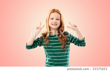 smiling red haired girl showing peace gesture smiling red haired girl showing peace gesture 55575831