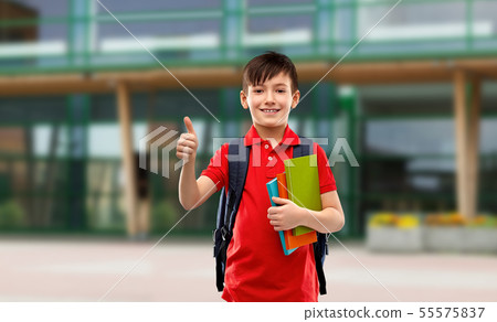 student boy with books and bag showing thumbs up student boy with books and bag showing thumbs up 55575837