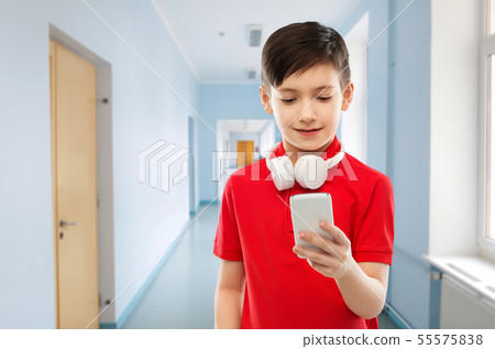 boy in red t-shirt with headphones and smartphone 55575838
