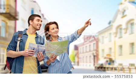 happy couple of tourists with city guide and map happy couple of tourists with city guide and map 55575853