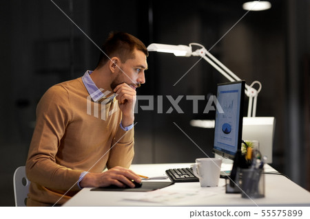 man with computer working late at night office 55575899
