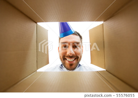 happy man opening parcel box or birthday gift 55576055