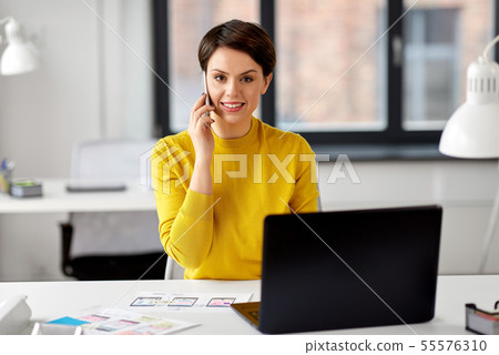 ui designer calling on smartphone at office ui designer calling on smartphone at office 55576310