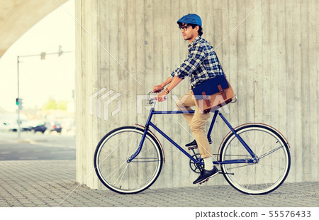 young hipster man with bag riding fixed gear bike young hipster man with bag riding fixed gear bike 55576433