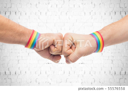 hands with gay pride wristbands make fist bump hands with gay pride wristbands make fist bump 55576558