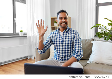 indian male blogger waving hand at home 55576737