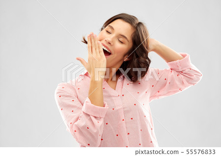 happy young sleepy woman in pajama yawning happy young sleepy woman in pajama yawning 55576833