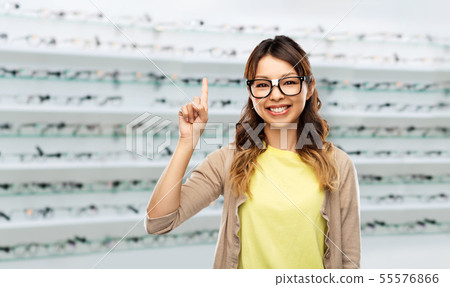 woman in glasses with finger up over optics store 55576866