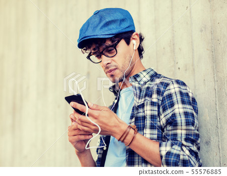 man with earphones and smartphone listening music 55576885