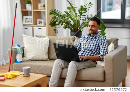 man with laptop computer after home cleaning 55576972