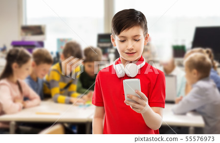 boy in red t-shirt with headphones and smartphone boy in red t-shirt with headphones and smartphone 55576973
