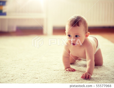 little baby in diaper crawling on floor at home little baby in diaper crawling on floor at home 55577068