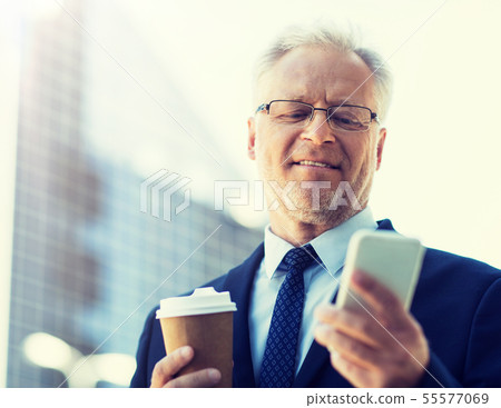 businessman with smartphone and coffee in city businessman with smartphone and coffee in city 55577069