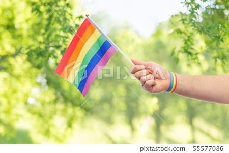 hand with gay pride rainbow flag and wristband 55577086